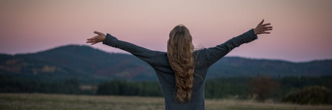 A portrait of a girl from behind just after sunset